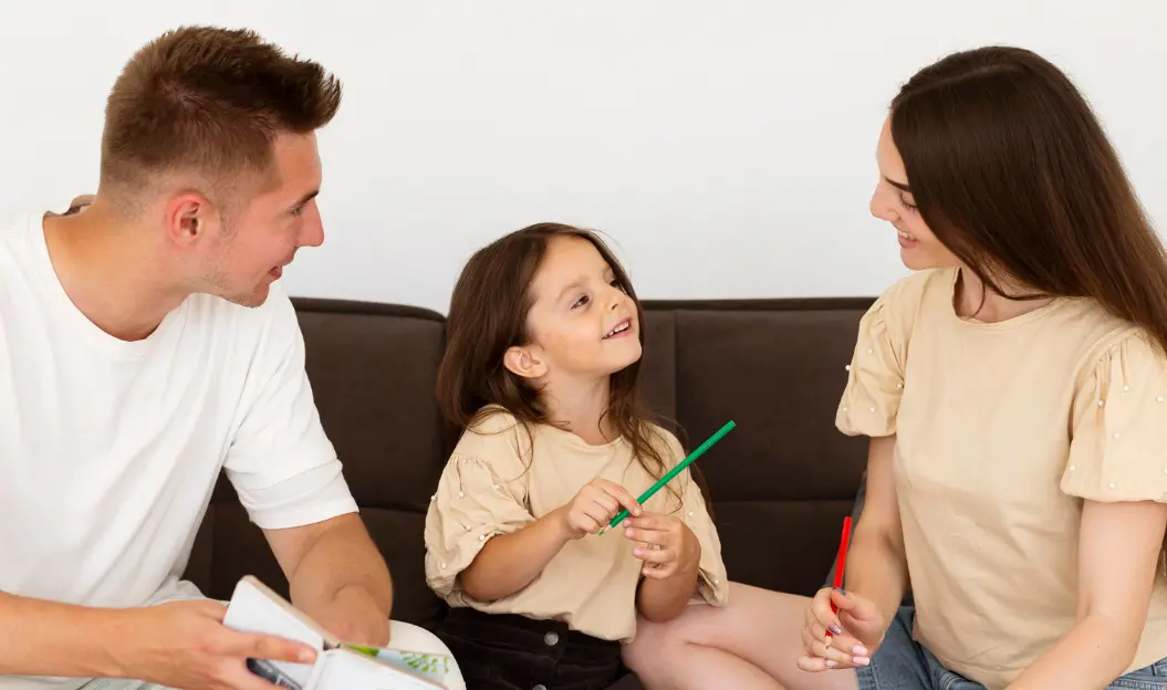 Parents talking to their daughter, illustrating how to explain drugs to a child in a supportive way.